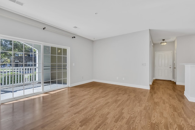 unfurnished room with light wood-type flooring