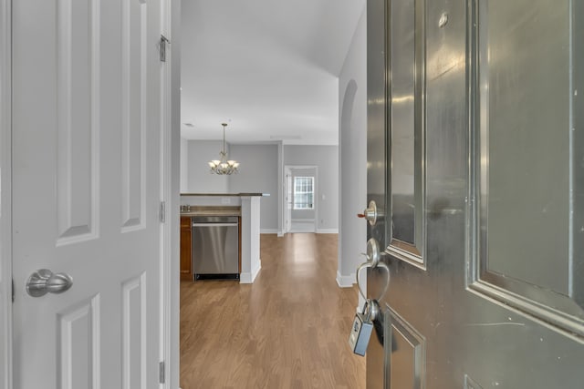 interior space with light hardwood / wood-style floors and a notable chandelier