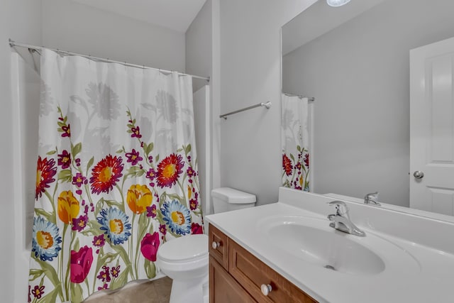 bathroom featuring toilet, a shower with curtain, vanity, and tile patterned flooring