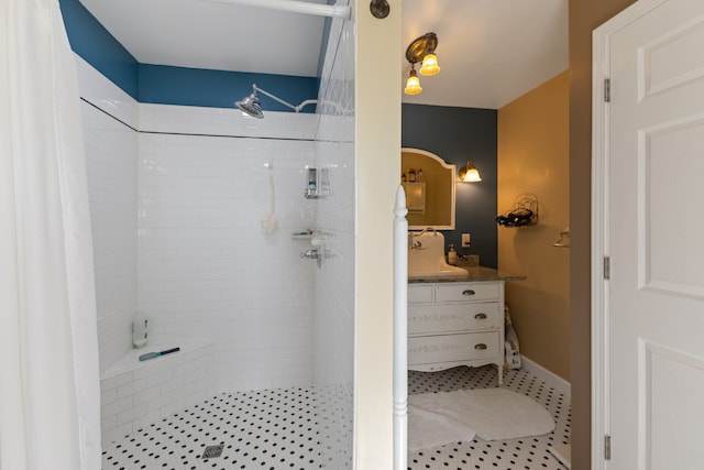 bathroom with a tile shower and sink