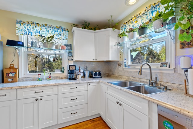 kitchen featuring white cabinetry, plenty of natural light, and sink