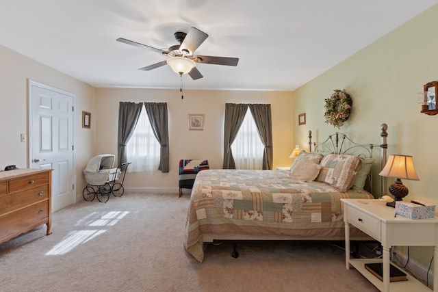 bedroom with ceiling fan and light carpet