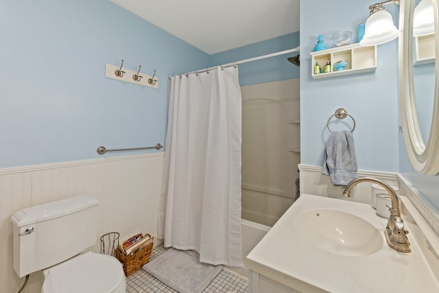 full bathroom featuring tile patterned floors, shower / bath combo with shower curtain, vanity, and toilet