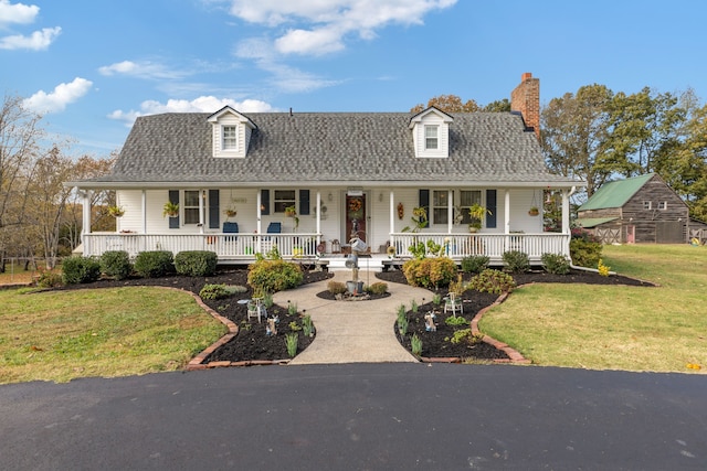 view of front of home featuring a front yard and a porch