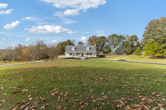 cape cod house with a front yard