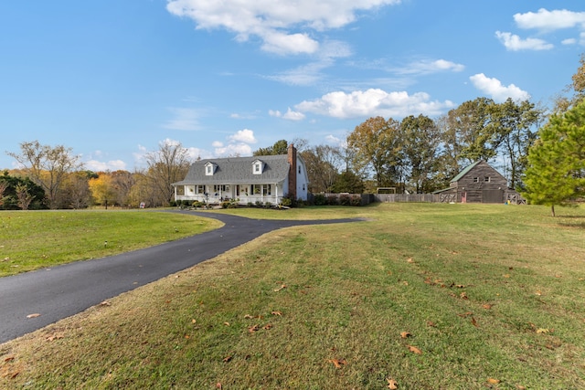 cape cod home with a front yard