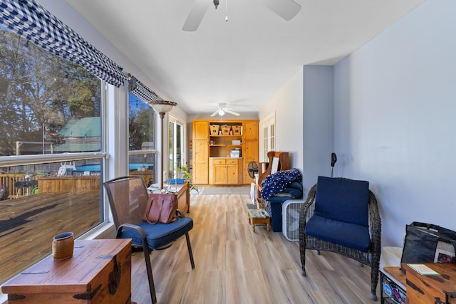 living area with plenty of natural light, light hardwood / wood-style floors, and ceiling fan