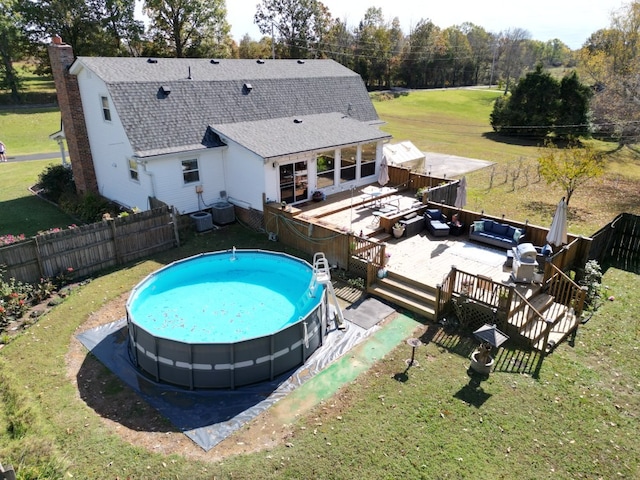 view of pool featuring a patio area, a yard, and central AC unit