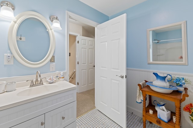 bathroom featuring tile patterned flooring, vanity, and walk in shower