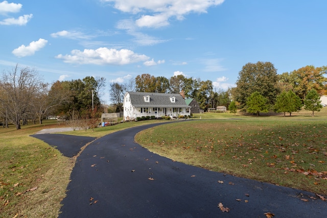 new england style home with a front yard