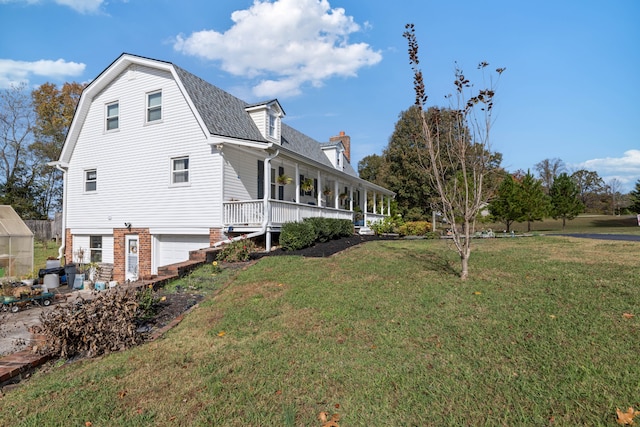 view of property exterior with a yard, a porch, and a garage