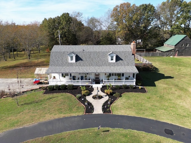 farmhouse-style home with a porch and a front lawn