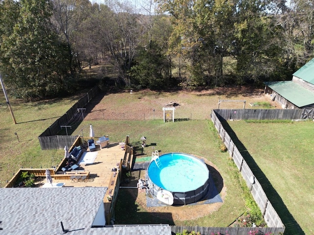 view of swimming pool featuring a lawn