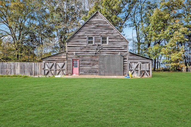 view of outbuilding featuring a yard