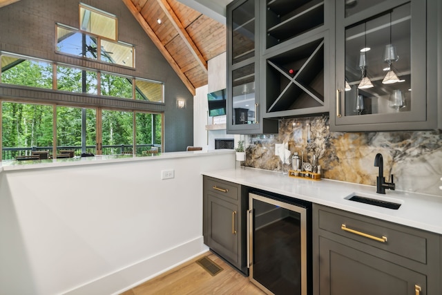 bar with lofted ceiling with beams, wine cooler, backsplash, wooden ceiling, and light hardwood / wood-style flooring