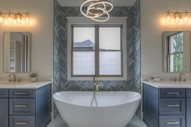 bathroom featuring vanity, a tub, and tile patterned flooring