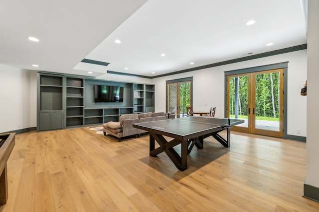 playroom featuring ornamental molding, french doors, and light wood-type flooring