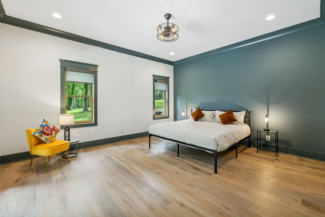 bedroom featuring light hardwood / wood-style flooring and crown molding