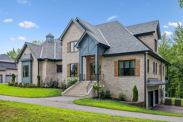 view of front of property with a front lawn, a garage, and cooling unit