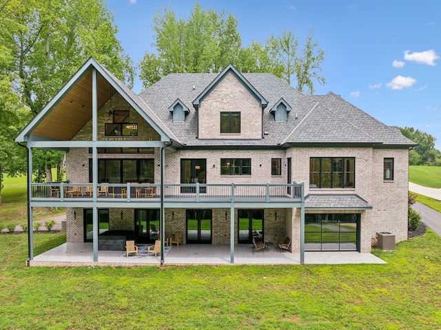 back of house featuring cooling unit, a lawn, and a patio