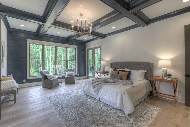 bedroom with light hardwood / wood-style flooring, beamed ceiling, coffered ceiling, and an inviting chandelier