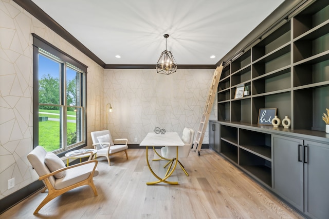 living area with ornamental molding, light wood-type flooring, and an inviting chandelier