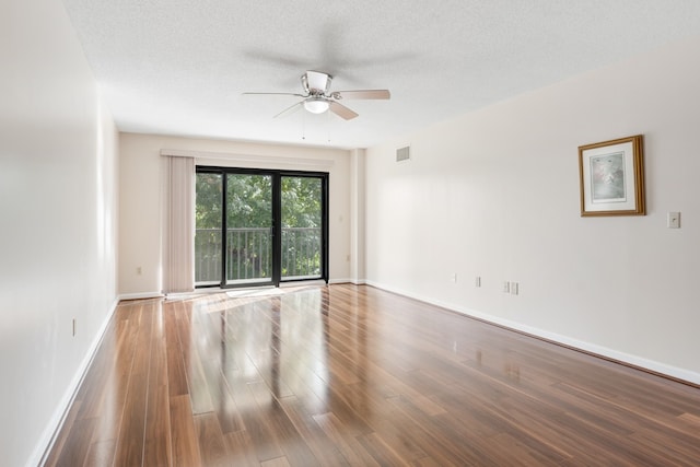 spare room featuring a textured ceiling, hardwood / wood-style flooring, and ceiling fan