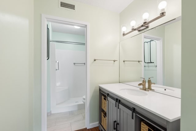 bathroom with toilet, a shower, vanity, and a textured ceiling