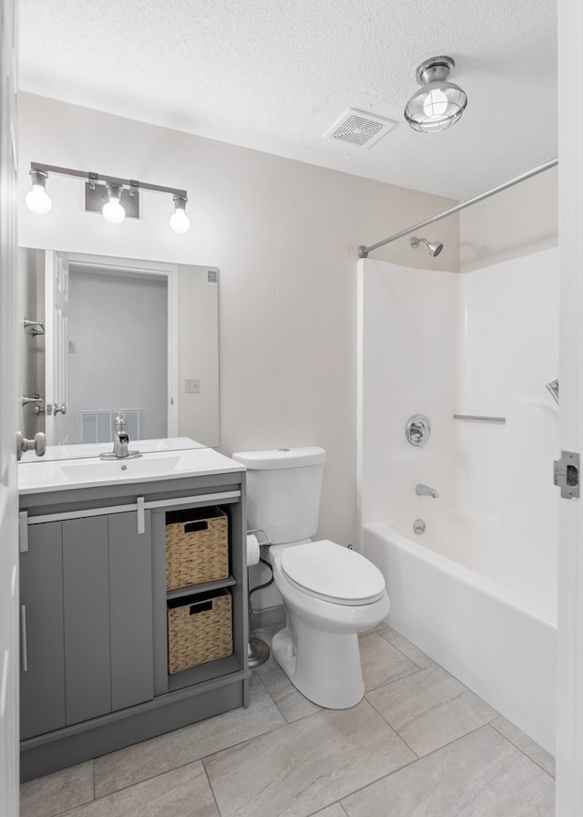 full bathroom featuring vanity, a textured ceiling, toilet, and tub / shower combination