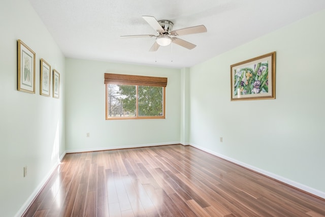 unfurnished room with hardwood / wood-style floors and ceiling fan