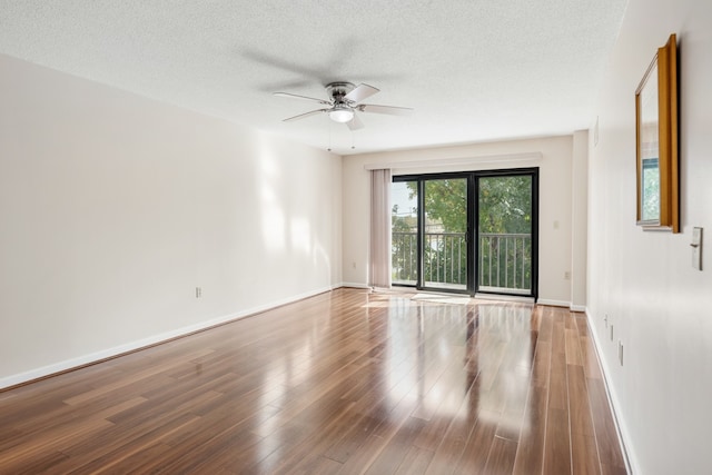 unfurnished room featuring hardwood / wood-style floors and a textured ceiling