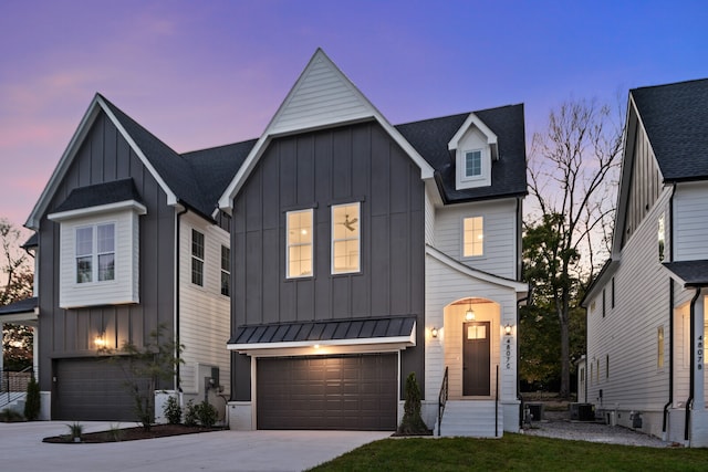 modern farmhouse style home with a garage and central air condition unit