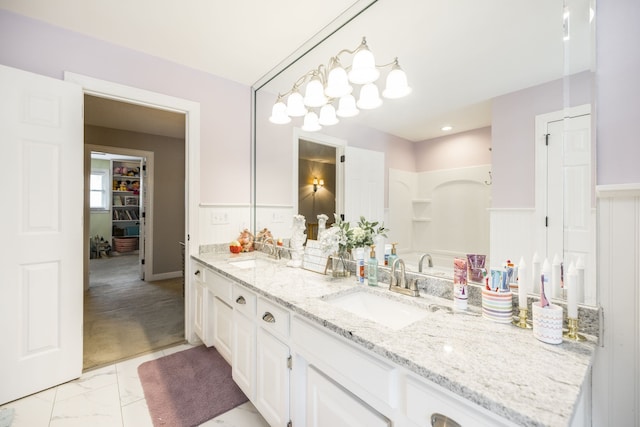 bathroom with walk in shower and vanity