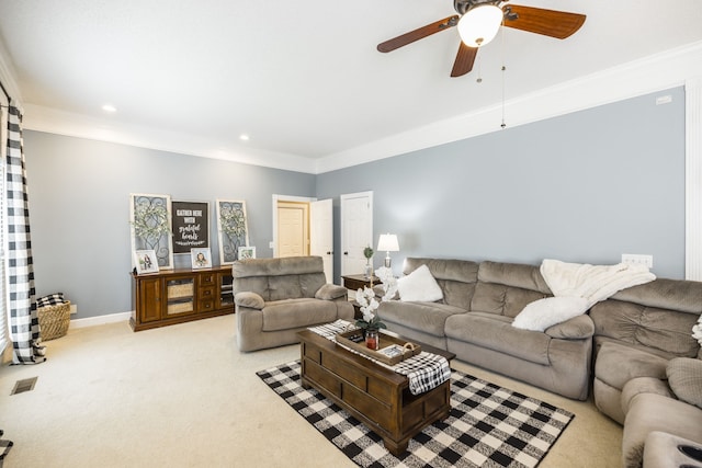 carpeted living room with ornamental molding and ceiling fan