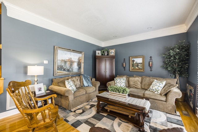 living room featuring hardwood / wood-style floors and crown molding