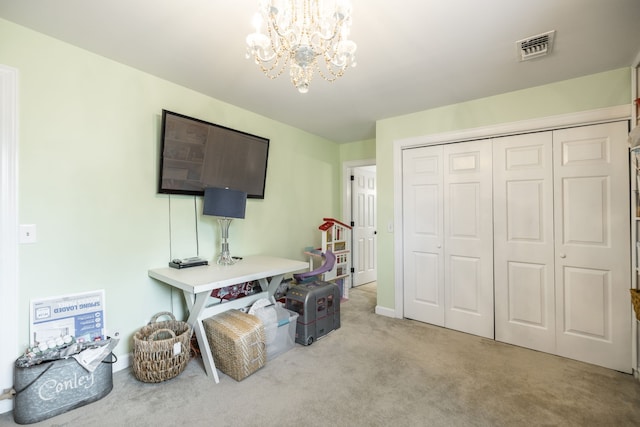 carpeted office space with an inviting chandelier