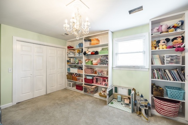 game room featuring light carpet and a notable chandelier