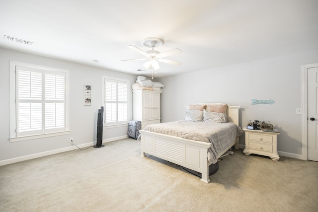 bedroom featuring light colored carpet and ceiling fan