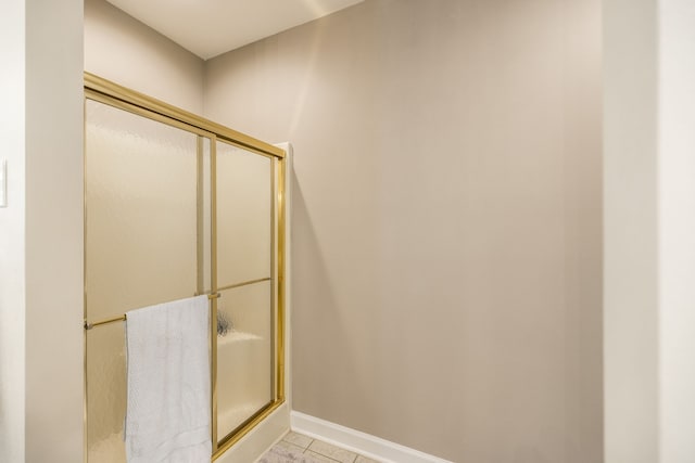 bathroom featuring tile patterned flooring and an enclosed shower