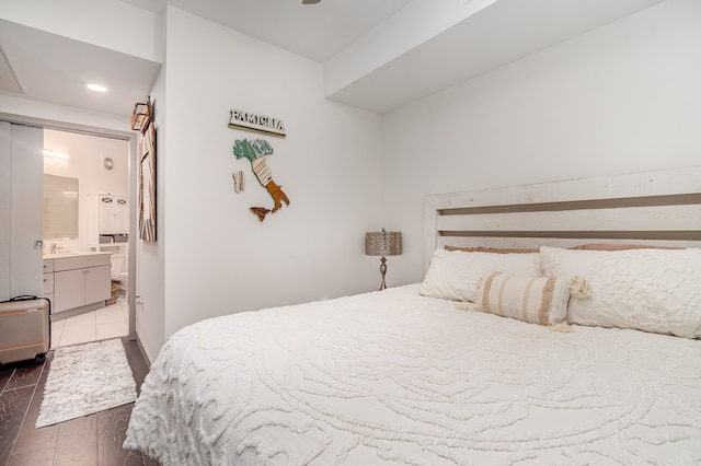 bedroom featuring sink, dark hardwood / wood-style floors, and ensuite bathroom