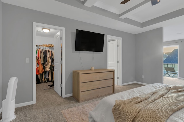 bedroom with ceiling fan, light colored carpet, access to outside, a walk in closet, and a closet