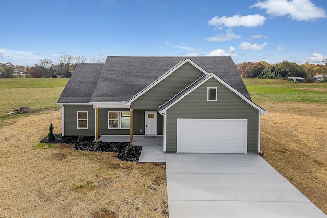 view of front of home featuring a garage and a front yard