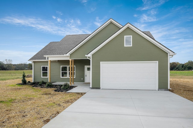 view of front of property with a garage and a front yard