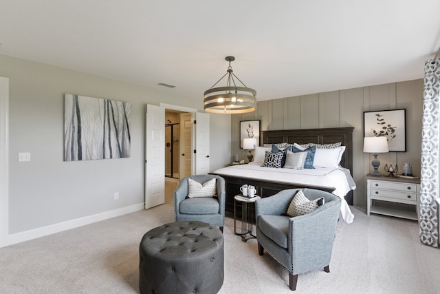 bedroom with light carpet and a notable chandelier