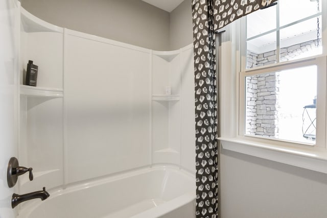 bathroom with plenty of natural light and shower / bath combo