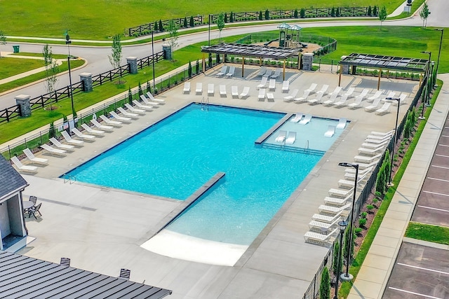 view of swimming pool featuring a yard and a patio area