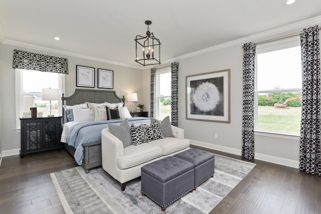 bedroom with dark hardwood / wood-style floors, an inviting chandelier, and ornamental molding