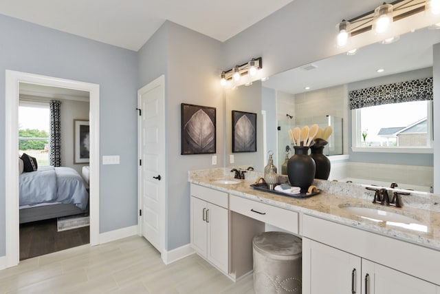 bathroom with a tile shower, vanity, and wood-type flooring