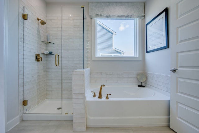 bathroom featuring tile patterned floors and independent shower and bath