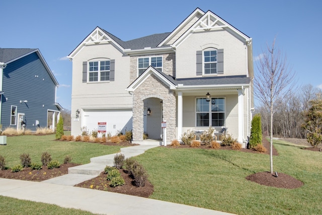 view of front of property with a garage and a front lawn